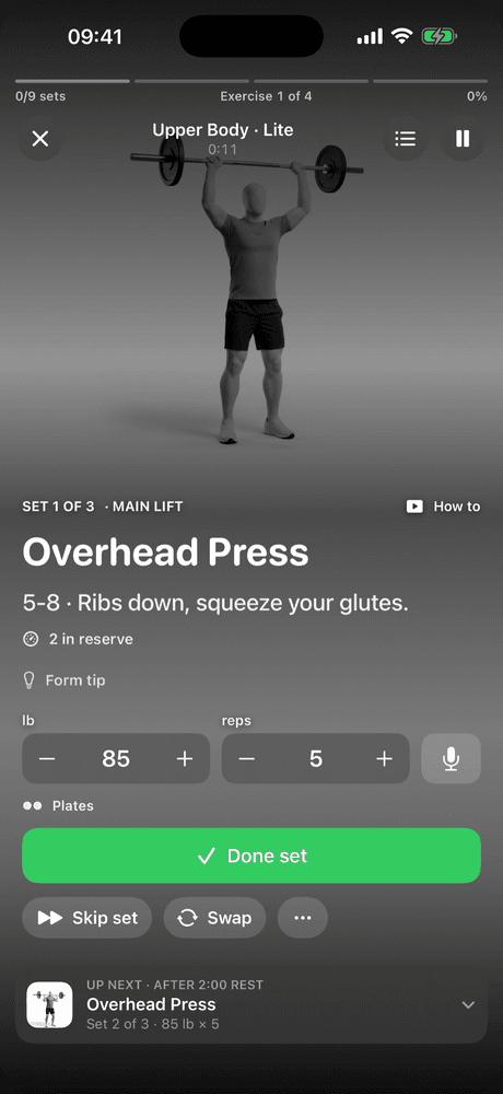 The Coachh workout player on set 1 of 3 of the overhead press: a 3D demo, the cue "ribs down, squeeze your glutes", 85 lb for 5 reps and a Done set button